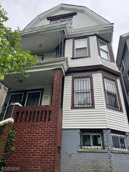 459 S 14th St, Newark City, NJ 07103 - view of home's exterior with a balcony and brick siding