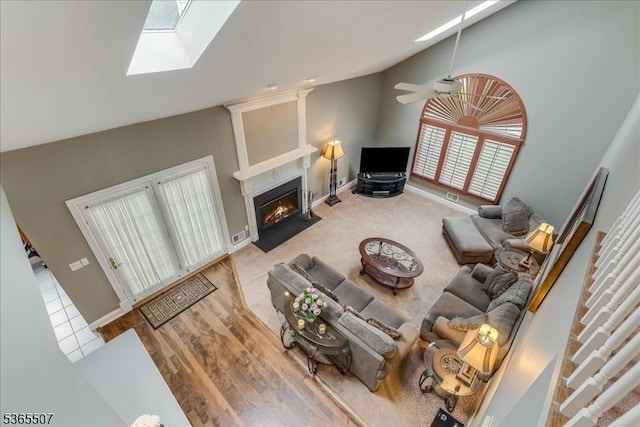 33 Gates Pl, Wayne Twp, NJ 07470 - living area featuring high vaulted ceiling, a fireplace with flush hearth, ceiling fan, and a skylight