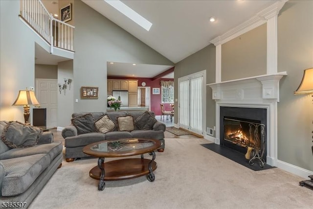 33 Gates Pl, Wayne Twp, NJ 07470 - living area with high vaulted ceiling, a fireplace with flush hearth, light colored carpet, and a skylight