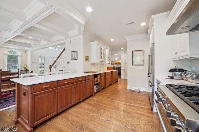 27 Green Way, New Providence Boro, NJ 07974 - kitchen featuring ventilation hood, light wood-style flooring, appliances with stainless steel finishes, light countertops, and backsplash
