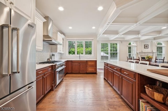 27 Green Way, New Providence Boro, NJ 07974 - kitchen featuring premium appliances, wall chimney range hood, light countertops, light wood finished floors, and crown molding