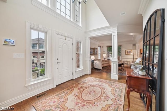 27 Green Way, New Providence Boro, NJ 07974 - entrance foyer with decorative columns, wood finished floors, and a towering ceiling