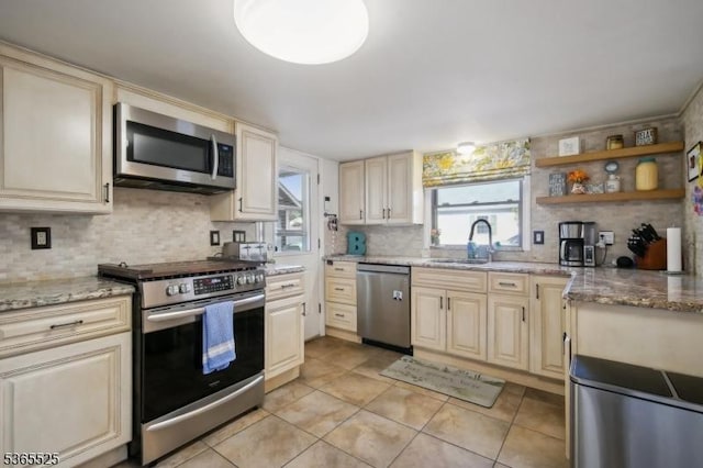 51 Greenbrook Rd, Middlesex Boro, NJ 08846 - kitchen featuring appliances with stainless steel finishes, decorative backsplash, and cream cabinetry