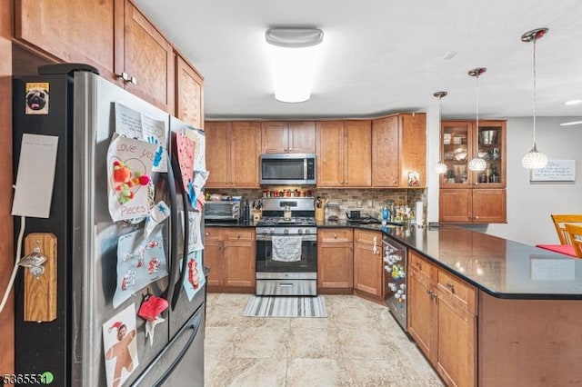 11 Manor Dr, Hillsborough Twp, NJ 08844 - kitchen with appliances with stainless steel finishes, a peninsula, dark countertops, and brown cabinetry