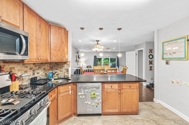 11 Manor Dr, Hillsborough Twp, NJ 08844 - kitchen with stainless steel appliances, a peninsula, a ceiling fan, dark countertops, and backsplash