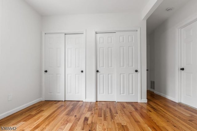 98 S Burnett St, East Orange City, NJ 07018 - unfurnished bedroom with multiple closets and light wood finished floors