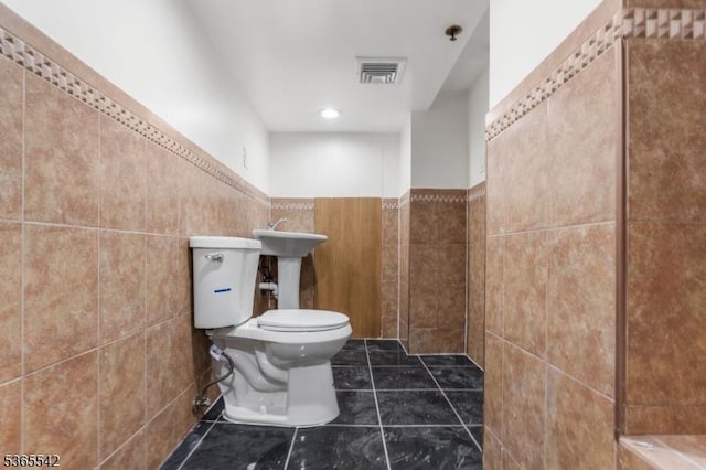 98 S Burnett St, East Orange City, NJ 07018 - bathroom featuring tile walls, tile patterned flooring, wainscoting, and recessed lighting