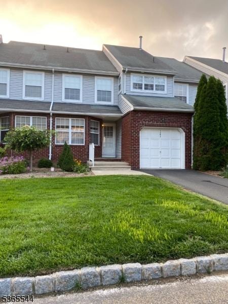 1203 Magnolia Ct, Washington Twp, NJ 07840 - townhome / multi-family property with a front lawn, a garage, brick siding, and driveway
