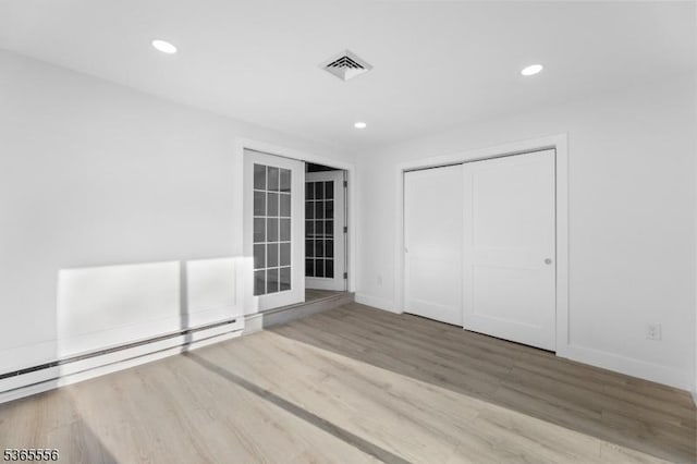 164 Cours De Clemenceau Unit E, Howell Twp, NJ 07728 - unfurnished bedroom with a baseboard radiator, wood finished floors, recessed lighting, and a closet