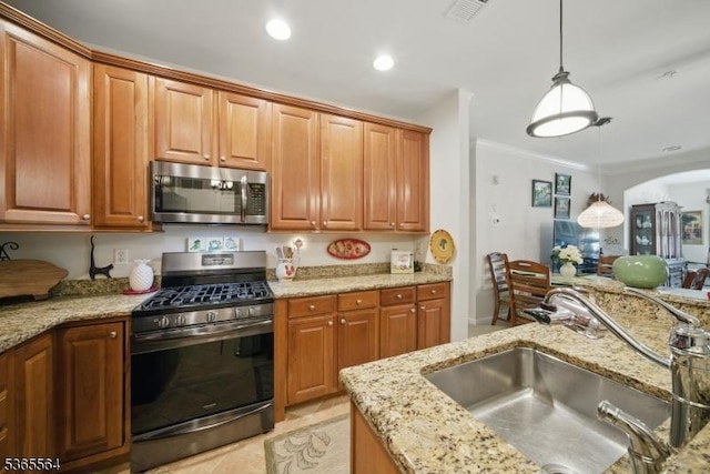 63 Ridgeview Ln, Mount Arlington Boro, NJ 07856 - kitchen with appliances with stainless steel finishes, hanging light fixtures, light stone countertops, arched walkways, and brown cabinets