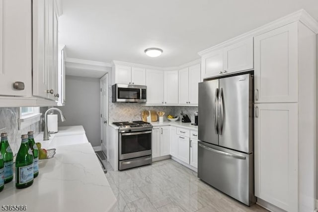 942 Summit Ave, Westfield Town, NJ 07090 - kitchen with stainless steel appliances, white cabinets, backsplash, light stone counters, and light marble finish floors