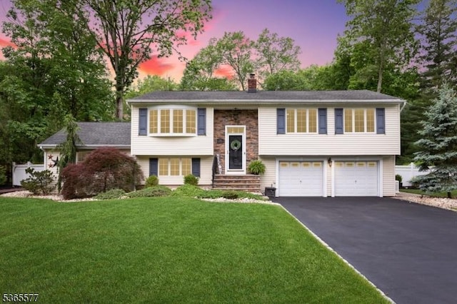 114 Fawn Ridge Dr, Long Hill Twp, NJ 07946 - bi-level home with driveway, a garage, a chimney, and a front yard