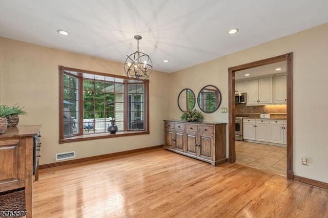 114 Fawn Ridge Dr, Long Hill Twp, NJ 07946 - dining area with a chandelier, light wood finished floors, and recessed lighting