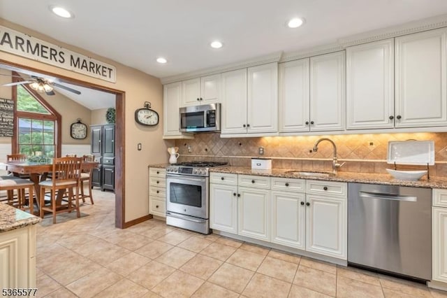 114 Fawn Ridge Dr, Long Hill Twp, NJ 07946 - kitchen featuring appliances with stainless steel finishes, ceiling fan, backsplash, light stone countertops, and recessed lighting