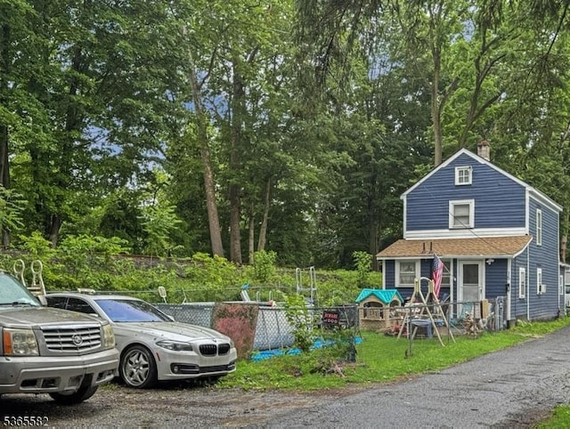 15 Fisk St, Belvidere Twp, NJ 07823 - view of front of house with a chimney and view of wooded area