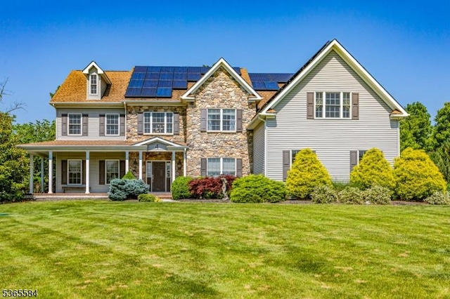 4 Wingover Farm Ct, Raritan Twp, NJ 08822 - view of front of home featuring a front yard, a porch, roof mounted solar panels, stone siding, and a chimney