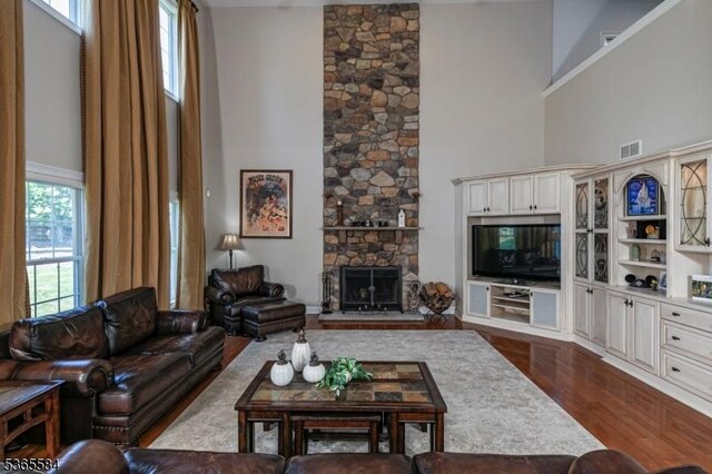 4 Wingover Farm Ct, Raritan Twp, NJ 08822 - living room featuring a towering ceiling, dark wood-style flooring, and a fireplace