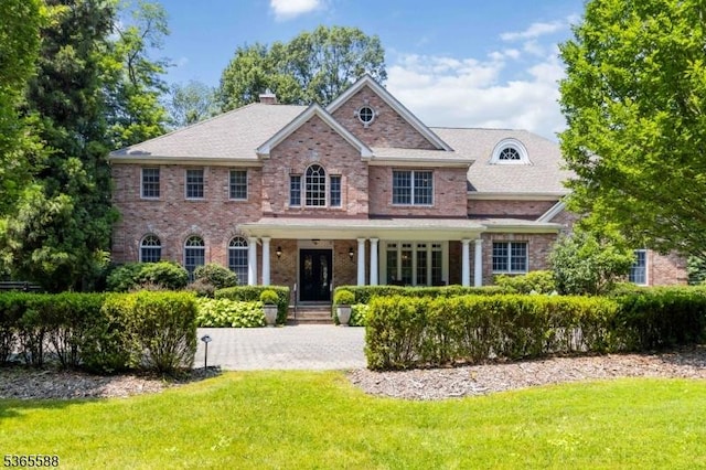 10 Westminster Pl, Morris Twp, NJ 07960 - colonial inspired home featuring a front lawn, a chimney, and brick siding