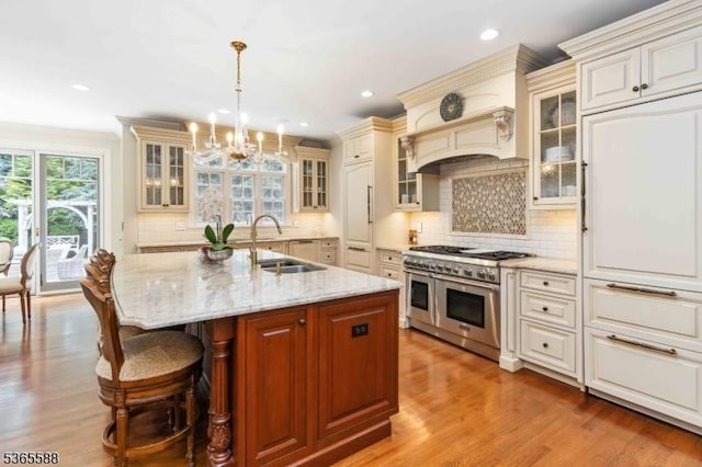 10 Westminster Pl, Morris Twp, NJ 07960 - kitchen with double oven range, a chandelier, backsplash, light stone countertops, and recessed lighting