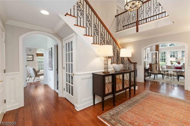 10 Westminster Pl, Morris Twp, NJ 07960 - entrance foyer featuring arched walkways, healthy amount of natural light, stairs, ornamental molding, and wood finished floors