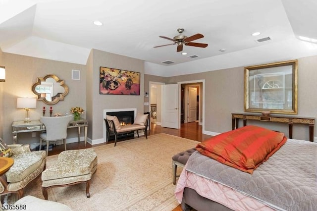10 Westminster Pl, Morris Twp, NJ 07960 - bedroom with wood finished floors, recessed lighting, a ceiling fan, a glass covered fireplace, and a tray ceiling