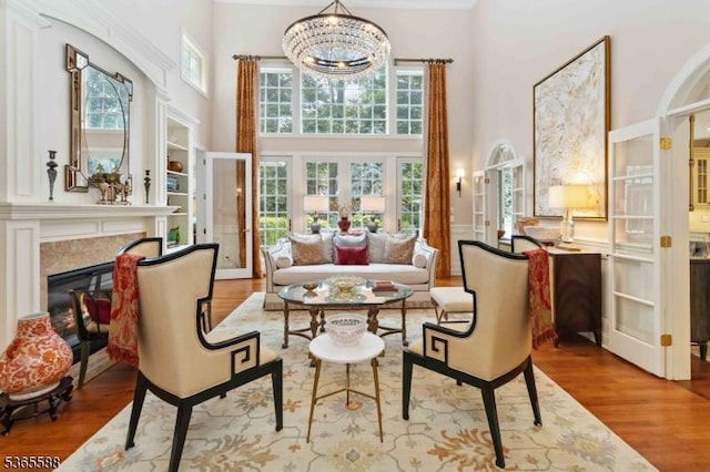 10 Westminster Pl, Morris Twp, NJ 07960 - living area with a high ceiling, wood finished floors, a chandelier, french doors, and a glass covered fireplace