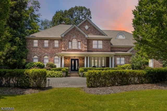 10 Westminster Pl, Morris Twp, NJ 07960 - colonial house with a front lawn, french doors, brick siding, and a chimney