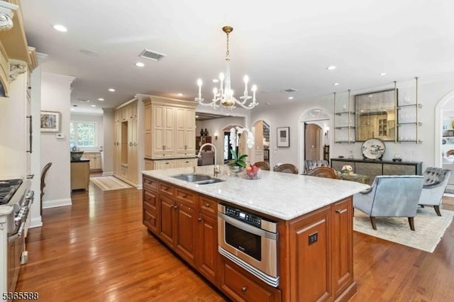 10 Westminster Pl, Morris Twp, NJ 07960 - kitchen with arched walkways, high end stainless steel range oven, wood finished floors, recessed lighting, and a center island with sink