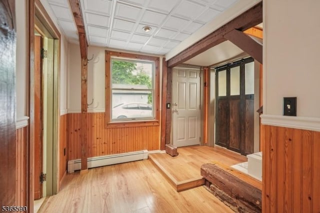 130 Ackerson Rd, Frelinghuysen Twp, NJ 07825 - doorway to outside with a baseboard heating unit, wood finished floors, a wainscoted wall, and wood walls