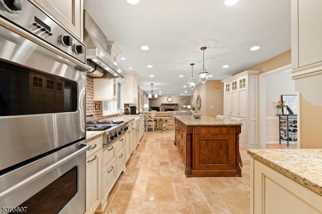10 Kilmer Dr, Hillsborough Twp, NJ 08844 - kitchen featuring appliances with stainless steel finishes, recessed lighting, open floor plan, hanging light fixtures, and light stone countertops