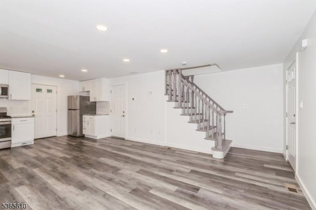 1489 Morris Ave, Union Twp, NJ 07083 - unfurnished living room with dark wood-type flooring, stairs, and recessed lighting