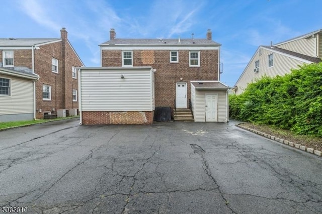 1489 Morris Ave, Union Twp, NJ 07083 - rear view of house featuring entry steps, a chimney, and brick siding