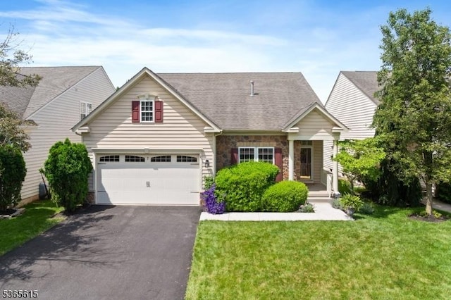 7 Thornton St, Hillsborough Twp, NJ 08844 - view of front facade with asphalt driveway, a front lawn, stone siding, and roof with shingles