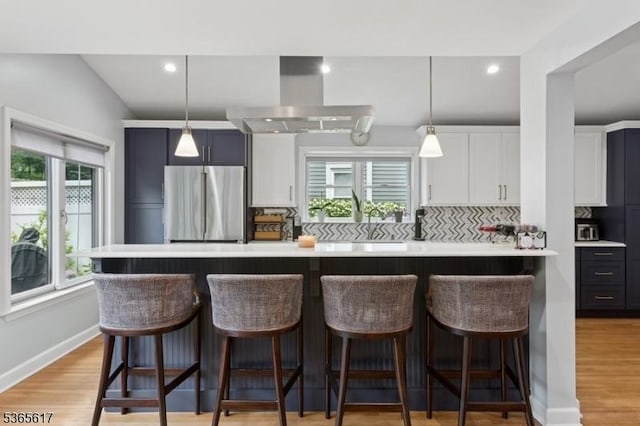 17 Lowell Ave, West Orange Twp, NJ 07052 - kitchen with stainless steel refrigerator, wall chimney exhaust hood, light countertops, backsplash, and recessed lighting