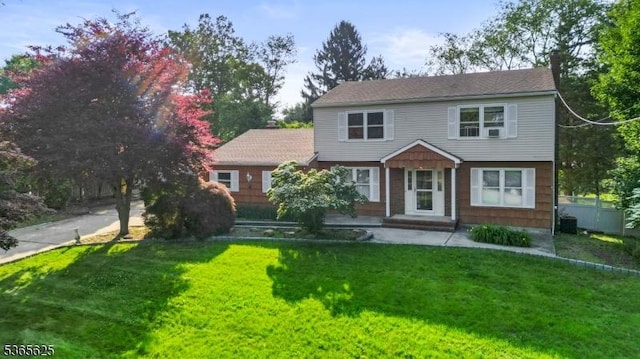 1265 Iris St, North Brunswick Twp, NJ 08902 - colonial-style house featuring a front yard and a chimney