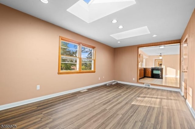 1265 Iris St, North Brunswick Twp, NJ 08902 - empty room with a skylight, wood finished floors, and recessed lighting