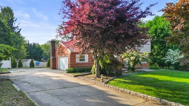 1265 Iris St, North Brunswick Twp, NJ 08902 - view of home's exterior featuring concrete driveway, a lawn, a chimney, and a garage