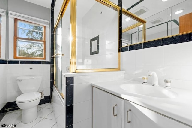 1265 Iris St, North Brunswick Twp, NJ 08902 - bathroom featuring tile walls, vanity, and combined bath / shower with glass door