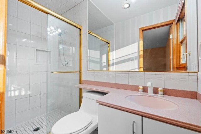 1265 Iris St, North Brunswick Twp, NJ 08902 - bathroom with tile walls, vanity, and a shower stall