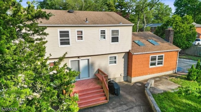 1265 Iris St, North Brunswick Twp, NJ 08902 - rear view of property featuring a deck and a shingled roof