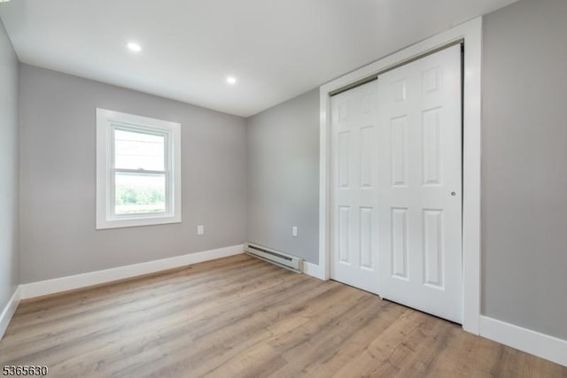 612 State Route 94, Fredon Twp, NJ 07860 - unfurnished bedroom with baseboard heating, light wood-type flooring, a closet, and recessed lighting
