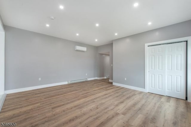 612 State Route 94, Fredon Twp, NJ 07860 - unfurnished bedroom featuring light wood finished floors, recessed lighting, a wall mounted AC, and a baseboard heating unit