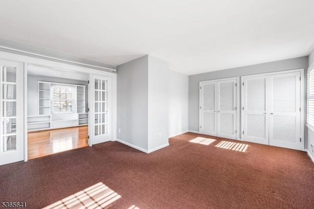 9 Village Ct, Flemington Boro, NJ 08822 - unfurnished living room with carpet flooring, built in features, and french doors