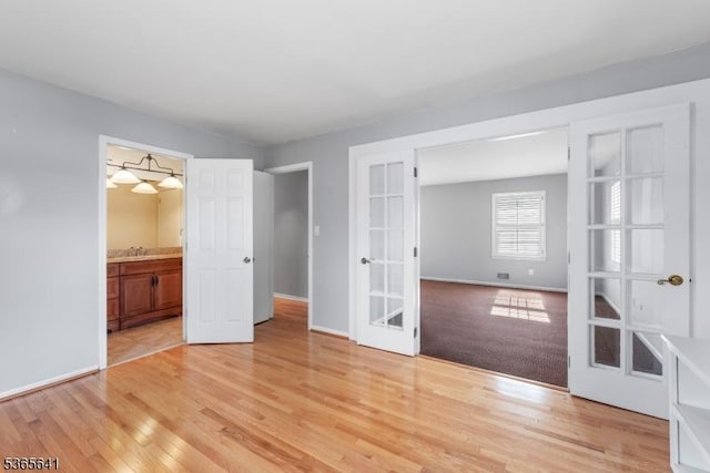 9 Village Ct, Flemington Boro, NJ 08822 - unfurnished bedroom featuring french doors and light wood finished floors