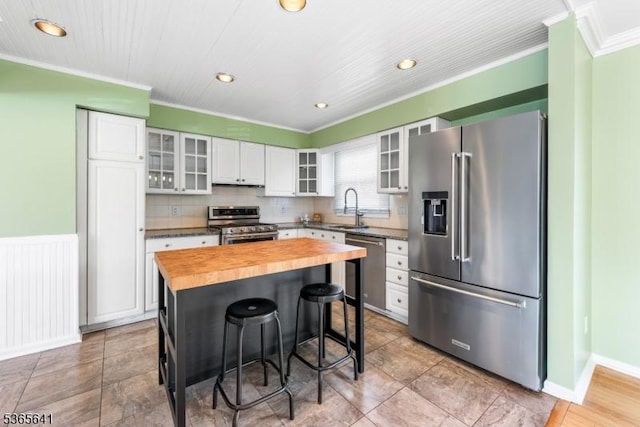 9 Village Ct, Flemington Boro, NJ 08822 - kitchen with appliances with stainless steel finishes, wooden counters, ornamental molding, a kitchen bar, and recessed lighting