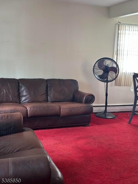 73 Berkeley Ter, Irvington Twp, NJ 07111 - carpeted living room featuring baseboard heating and baseboards