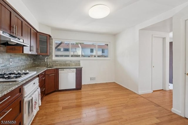 922C Merritt Dr, Hillsborough Twp, NJ 08844 - kitchen featuring white appliances, under cabinet range hood, light wood-type flooring, glass insert cabinets, and light stone countertops