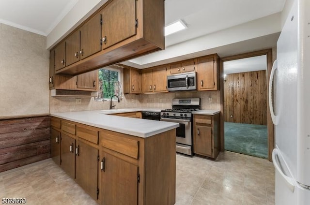 708 Carlene Dr, Bridgewater Twp, NJ 08807 - kitchen with appliances with stainless steel finishes, a peninsula, light countertops, decorative backsplash, and crown molding