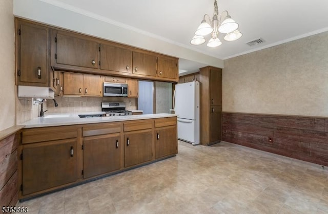 708 Carlene Dr, Bridgewater Twp, NJ 08807 - kitchen featuring appliances with stainless steel finishes, a chandelier, light countertops, light floors, and ornamental molding