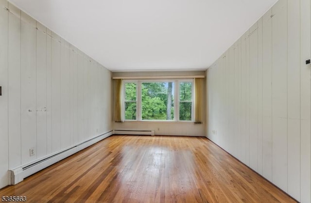 708 Carlene Dr, Bridgewater Twp, NJ 08807 - unfurnished room with wood finished floors, a baseboard radiator, and wooden walls